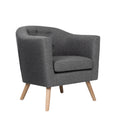 Grey fabric tub armchair with button-tufted back and natural wood tapered legs, angle view on white background
