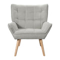 Light grey fabric grid-tufted wingback armchair with natural wood legs front view on white background