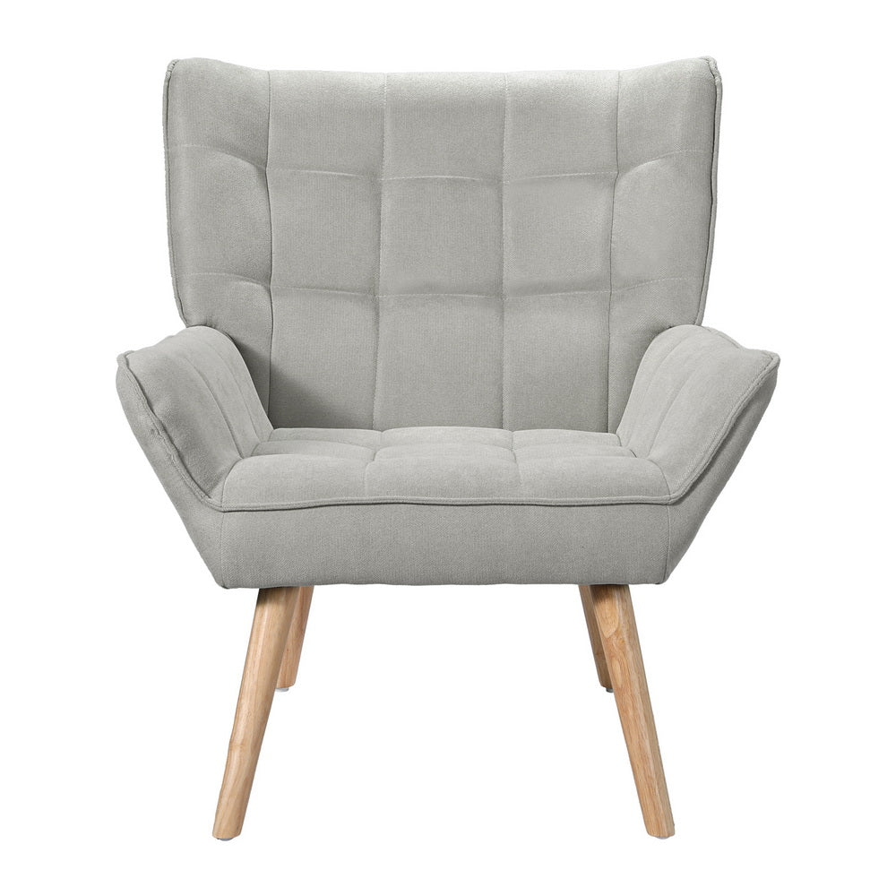 Light grey fabric grid-tufted wingback armchair with natural wood legs front view on white background