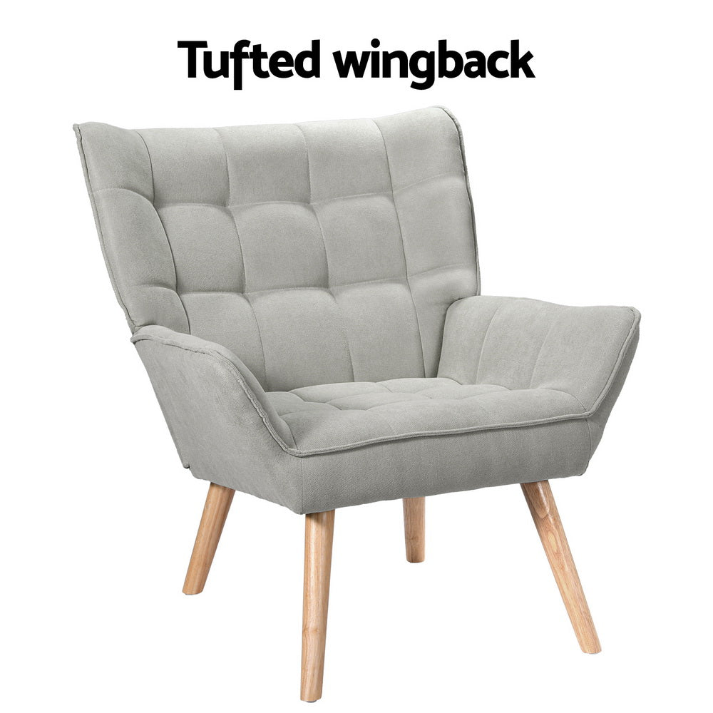 Light grey fabric grid-tufted wingback armchair with natural wood legs and Tufted wingback text on white background