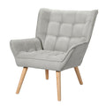 Light grey fabric grid-tufted wingback armchair with natural wood splayed legs angle view on white background
