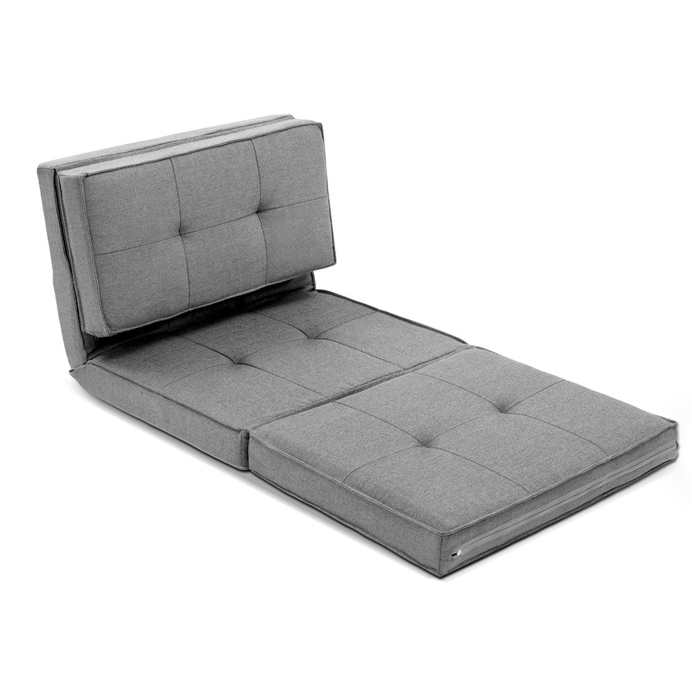Grey linen foldable floor lounger at angle in semi-reclined position on white background