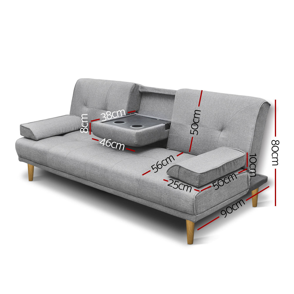 Light grey linen 3-seat sofa bed with fold-down cupholder tray open, two bolster arm pillows and wood legs