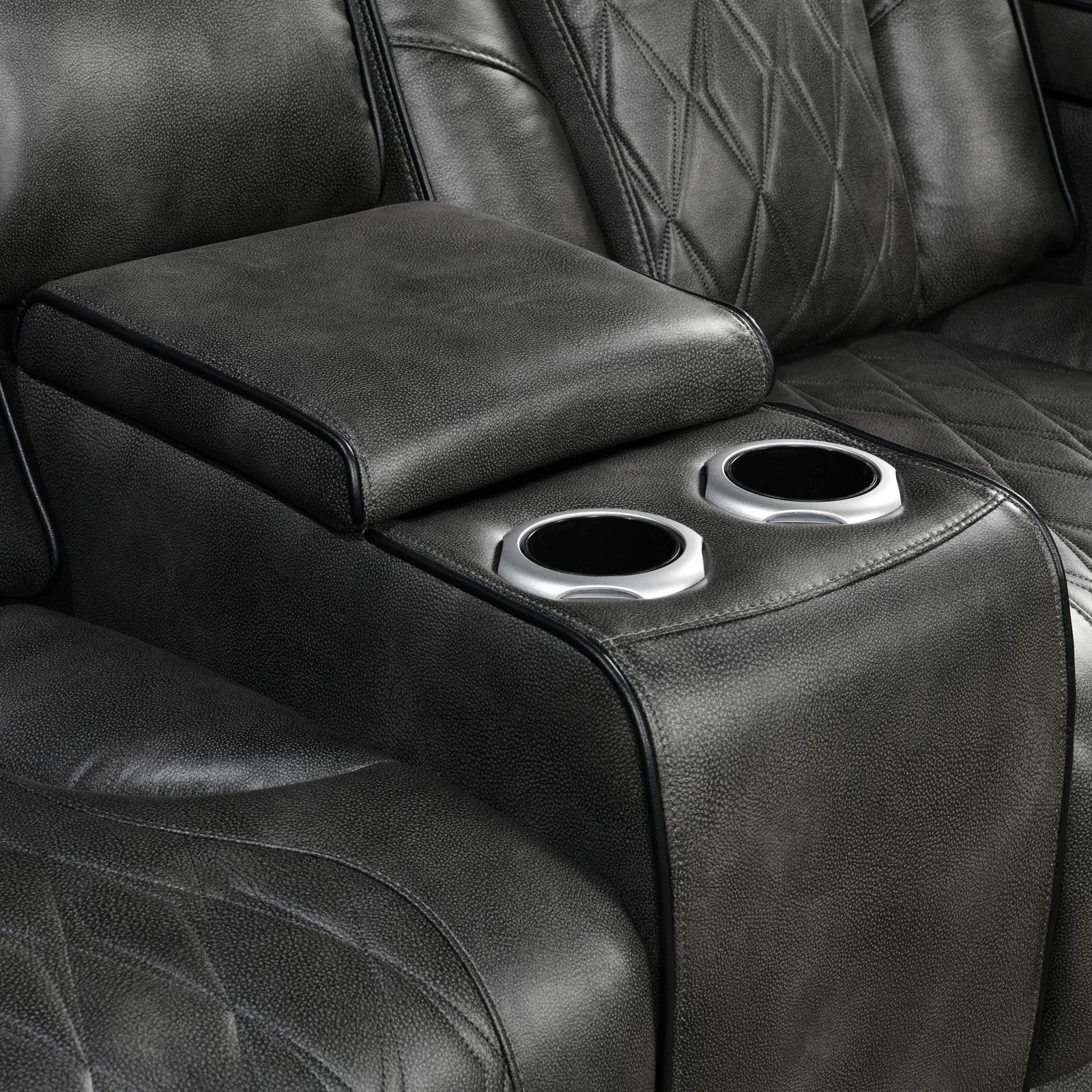 Close-up of grey leather recliner center console lid open with two silver cup holders visible