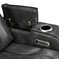 Close-up of grey leather recliner open storage tray with silver hinges, cup holder and control panel