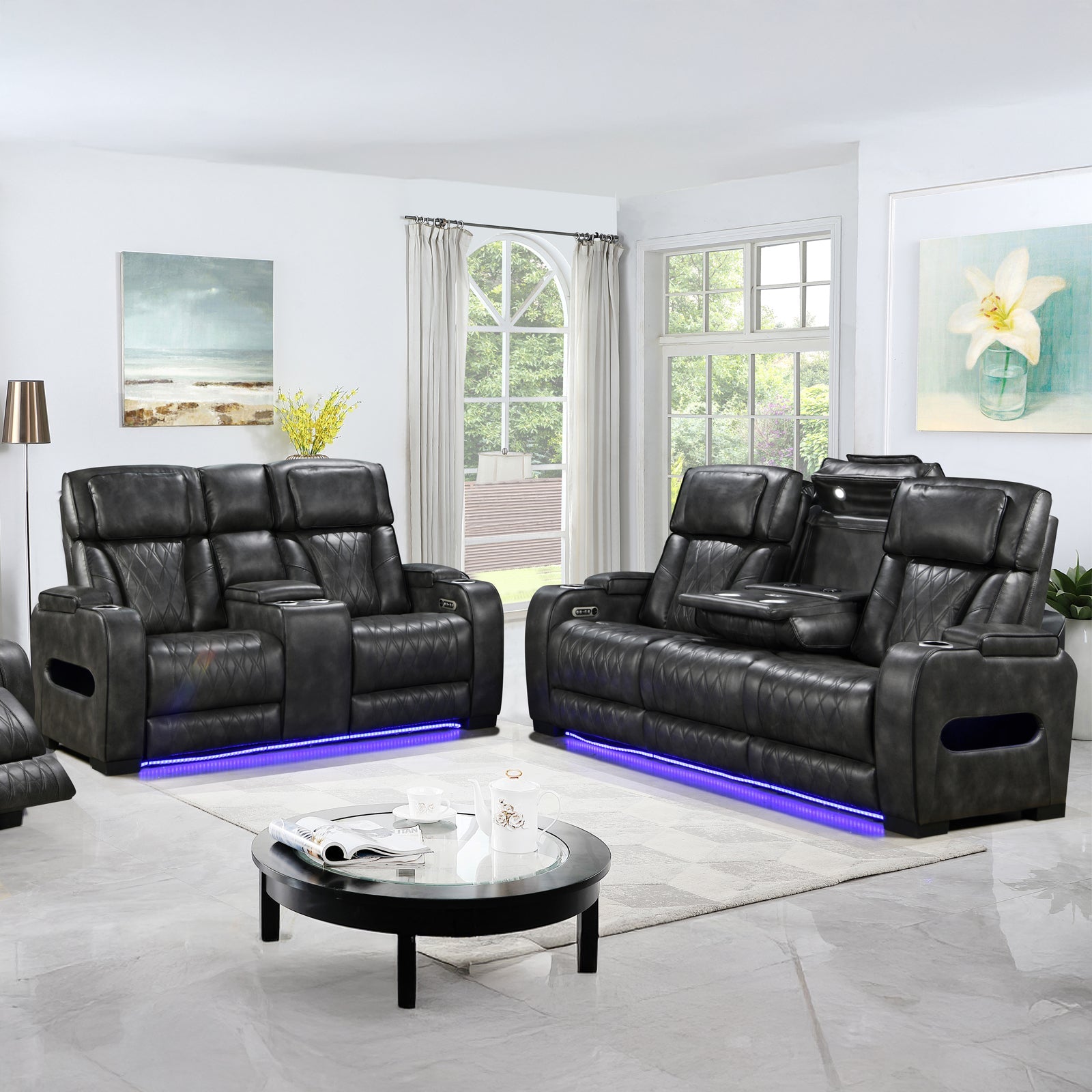 Dark charcoal leather power recliner sofa and loveseat set with blue LED lighting in bright living room