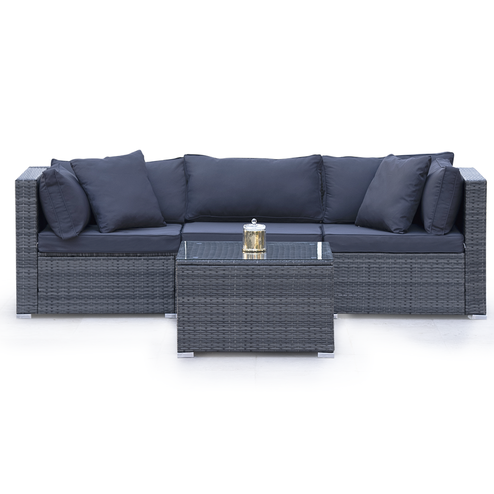 Grey rattan 3-seater outdoor lounge set with navy cushions and glass-top coffee table, lantern on table, white background