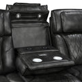 Close-up of dark grey leather recliner open fold-down console showing cup holders and control buttons