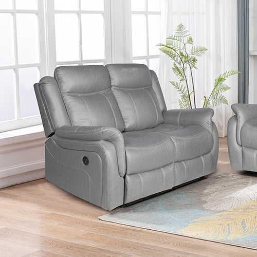 Grey electric recliner 2-seater sofa in living room with one seat partially reclined and plant