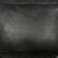 Close-up of dark charcoal pebbled leather seat cushion texture on power recliner