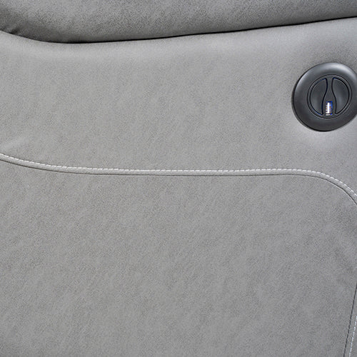Close-up of grey electric recliner sofa arm showing round black electric recline button