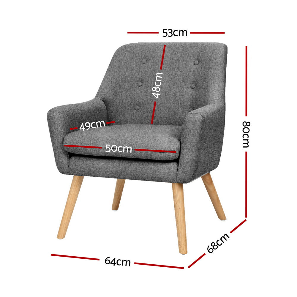 Pair of dark grey button-tufted fabric armchairs with natural wood legs, three-quarter view on white background