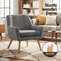 Dark grey tufted armchair in living room, 