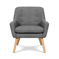 Dark grey button-tufted fabric armchair with six buttons on backrest, natural wood legs, front view on white background