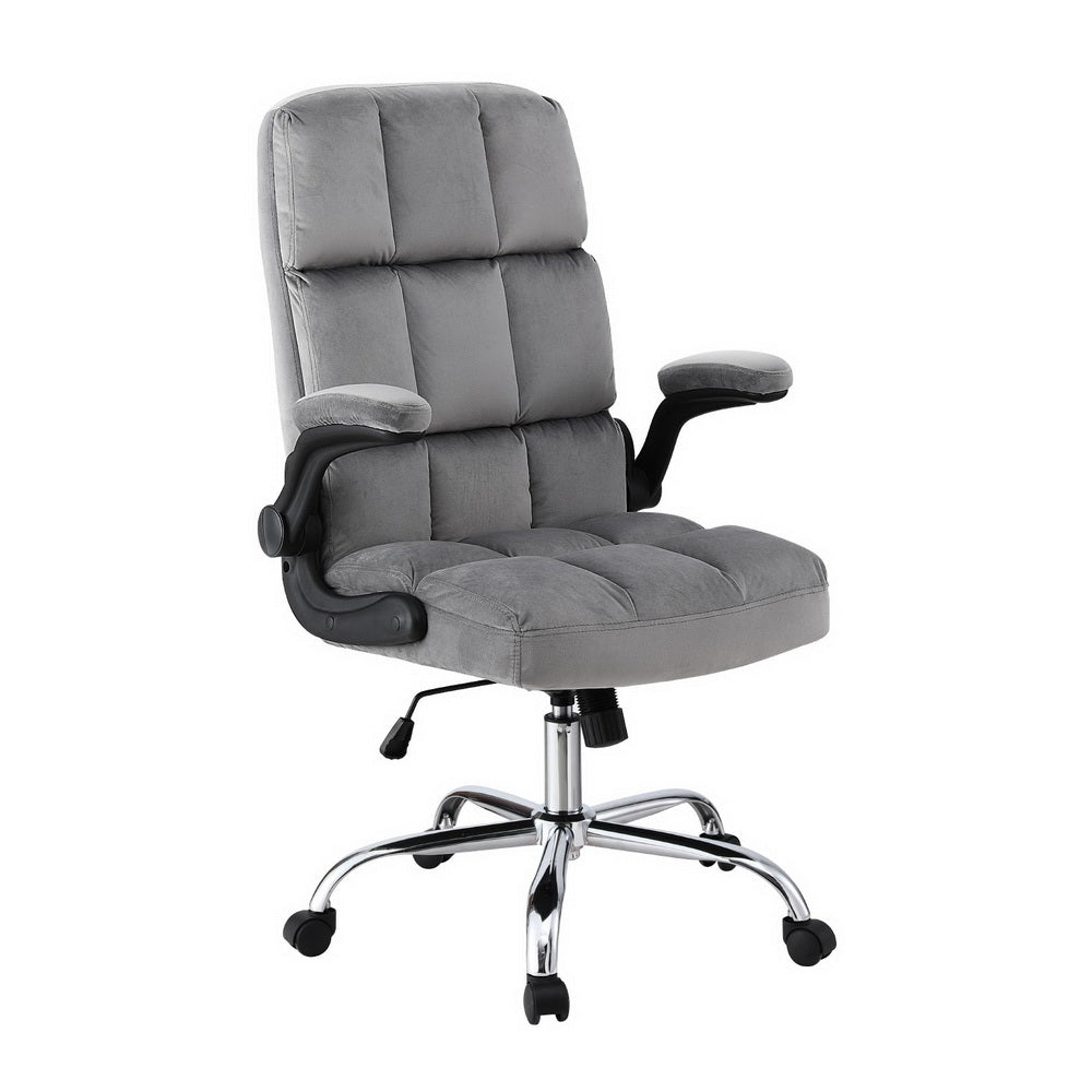 Grey tufted velvet high-back office chair three-quarter angle view with flip-up armrests and chrome base on white