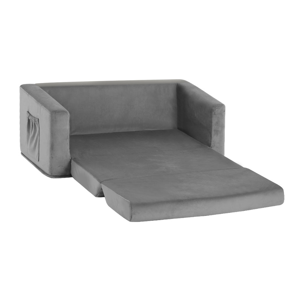 Grey velvet kids sofa bed fully extended flat with side pocket visible on white background