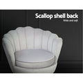 Grey velvet scallop chair close-up against dark background showing channel-stitched shell back with Scallop shell back text