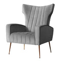 Grey velvet wingback armchair with tall winged back and vertical channel stitching angle view on white background
