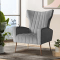 Grey velvet wingback armchair in lifestyle room setting with large tropical plant and Soft velvet text callout