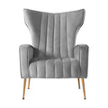 Grey velvet wingback armchair with tall winged back and vertical channel stitching front view on white background