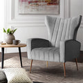 Grey velvet wingback armchair with vertical channel stitching and gold metal legs in living room lifestyle scene