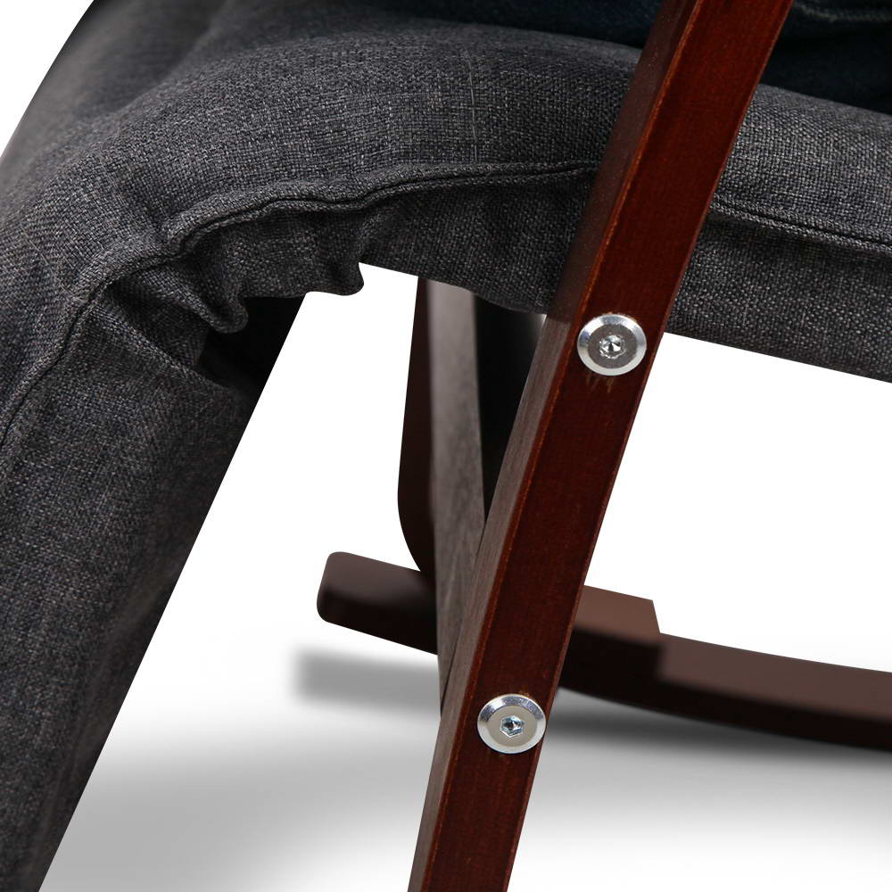Close-up detail of grey fabric cushion and walnut-stained bentwood frame joint with visible silver bolts on white background