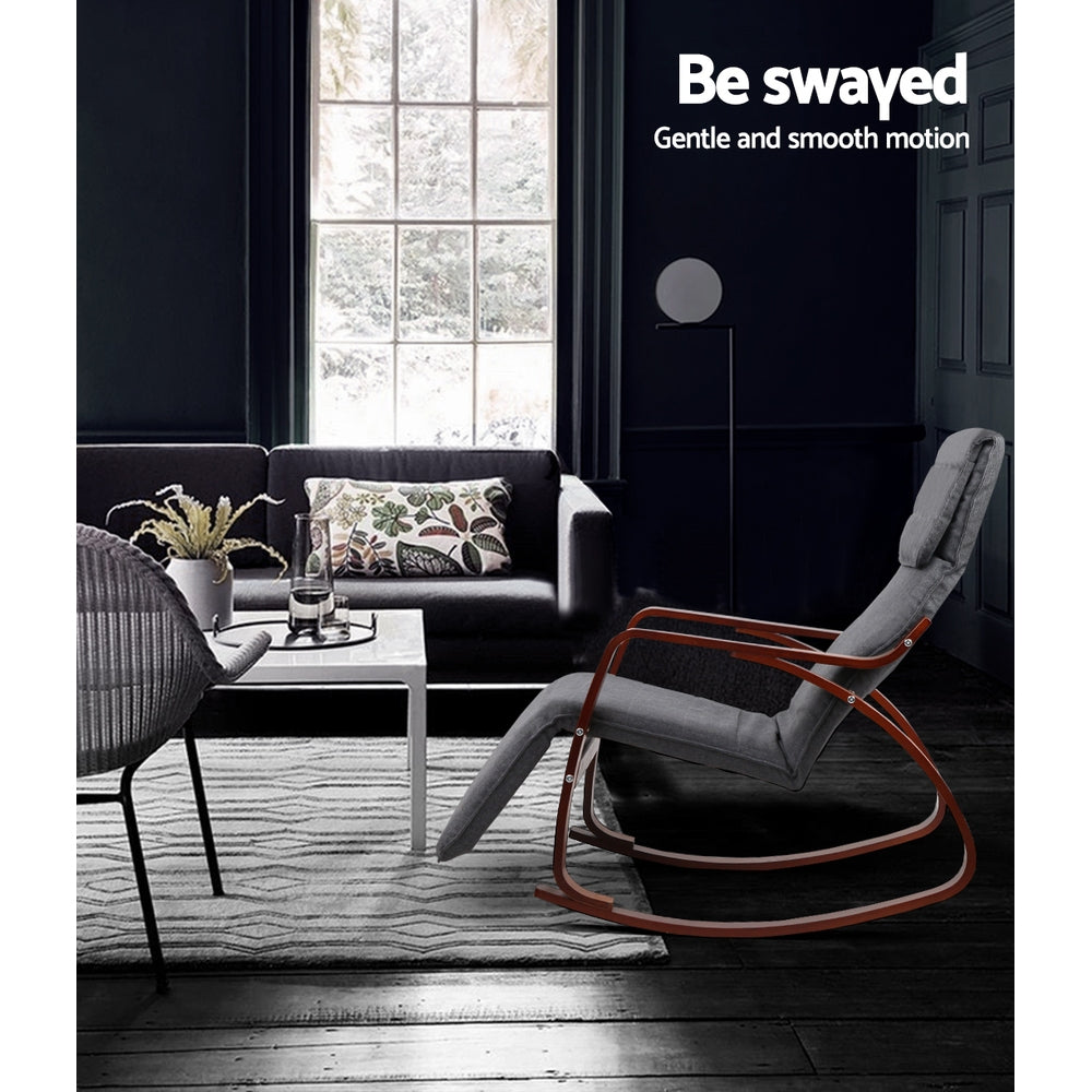 Grey walnut rocking recliner in dark living room with sofa and patterned rug, text: Be swayed, Gentle and smooth motion
