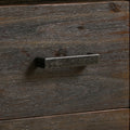 Extreme close-up of dark charcoal wood drawer face with hammered pewter-finish rectangular metal bar handle