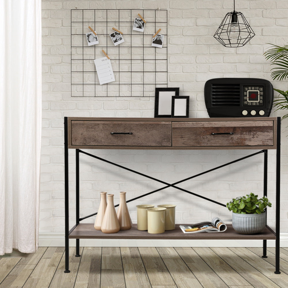 Industrial console table with 2 drawers and bottom shelf styled in brick-wall room with vintage radio and wire photo board