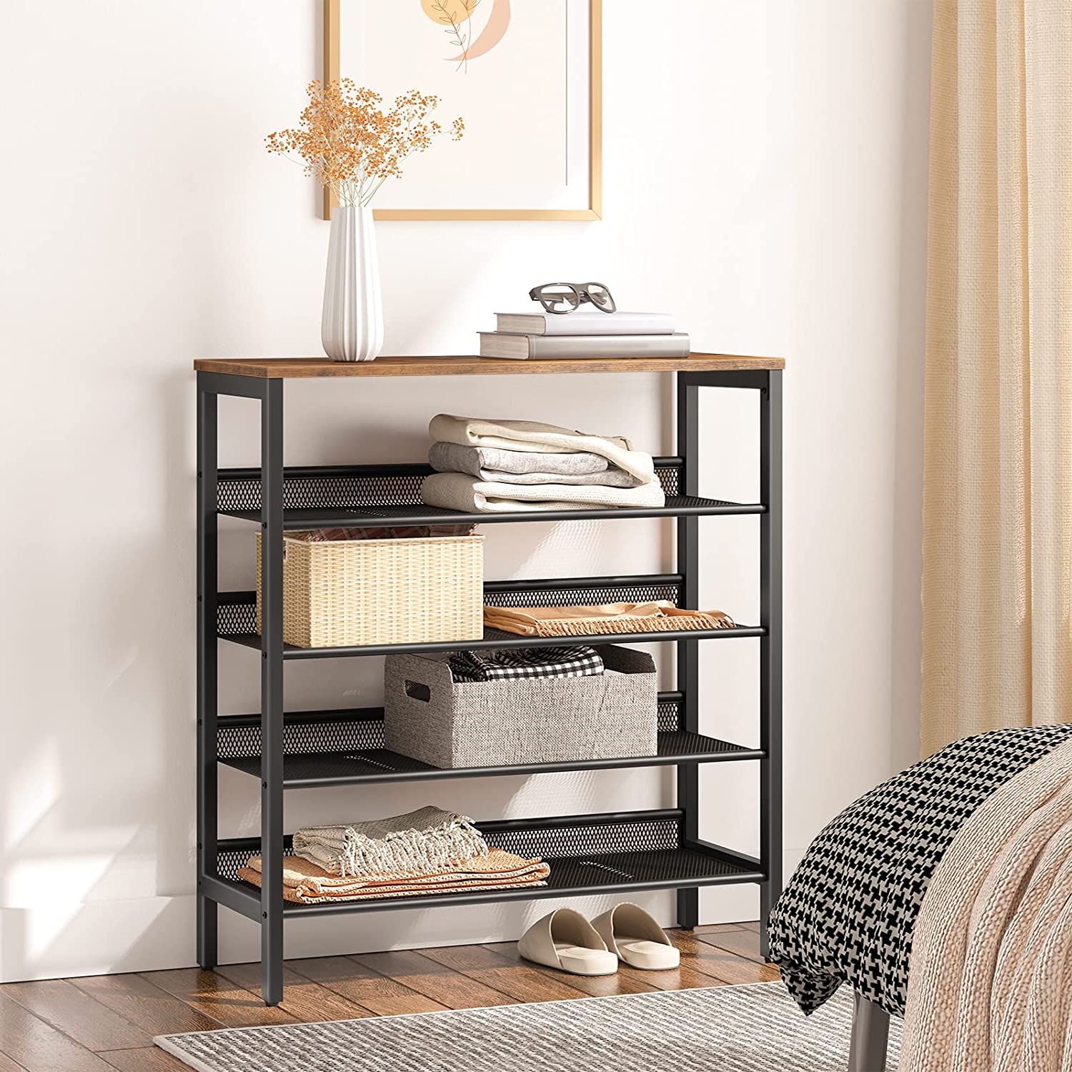 Industrial mesh rack used as bedroom storage with folded clothes, baskets and rustic wood top with vase