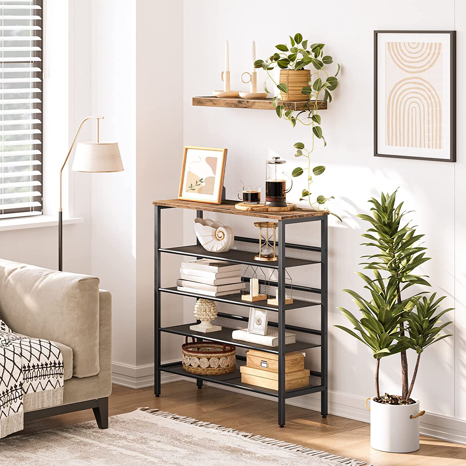 Industrial mesh rack styled as living room side unit with books, decorative items and plant beside sofa