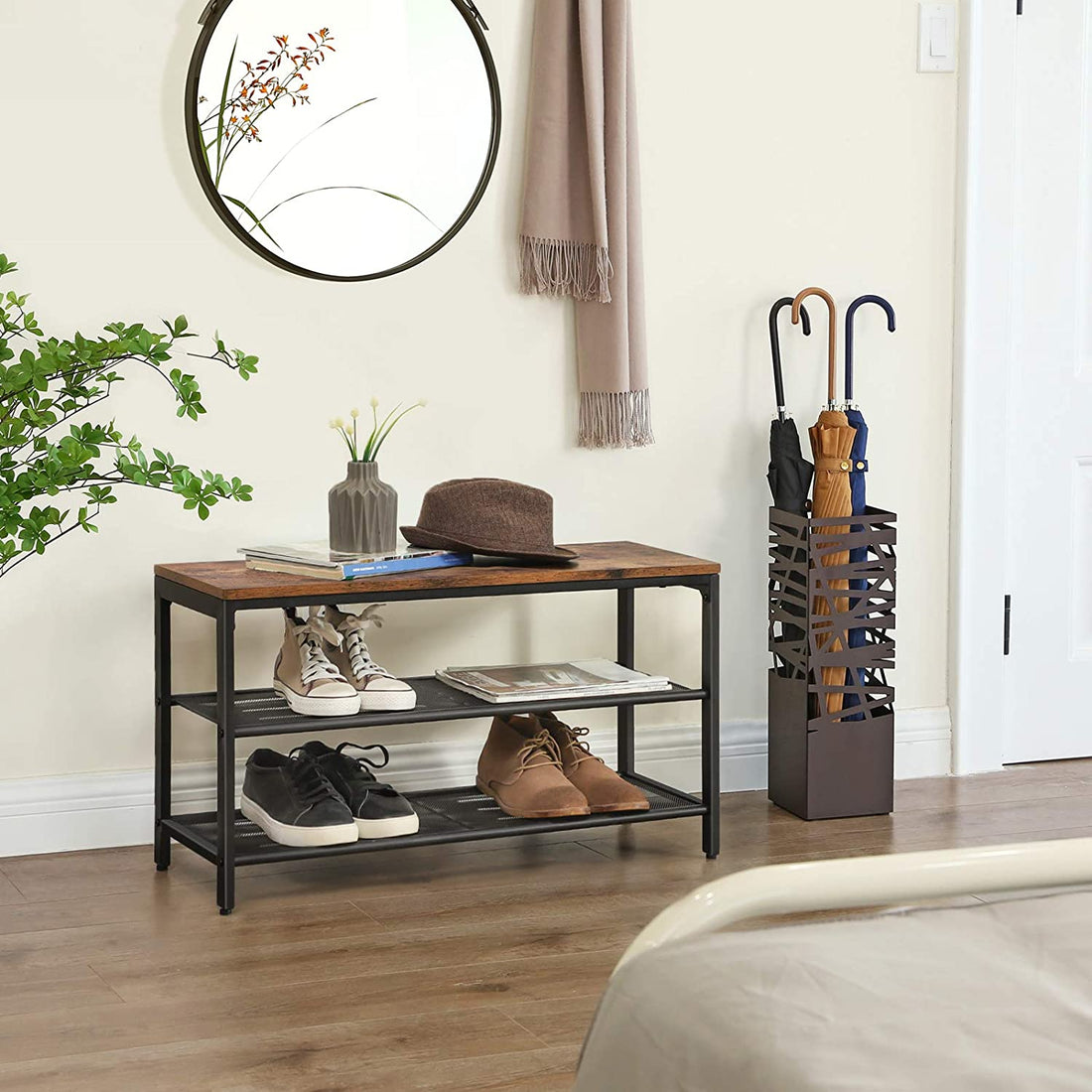 Industrial shoe bench with rustic brown wood top and two black wire mesh shelves on white background