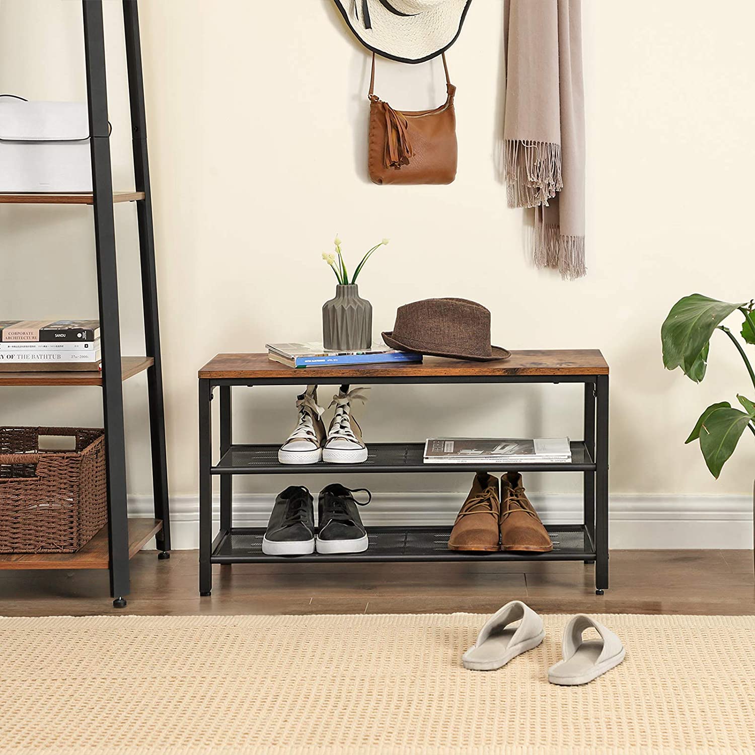Industrial shoe bench in entryway with handbag on wall hook ladder shelf to the side and slippers on floor