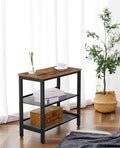 Industrial side table beside curtained window, glass vase on top, books and basket on shelves, plant nearby