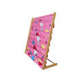 Pink strawberry-print fabric book display rack, empty, three-quarter angle view with bamboo A-frame on white background