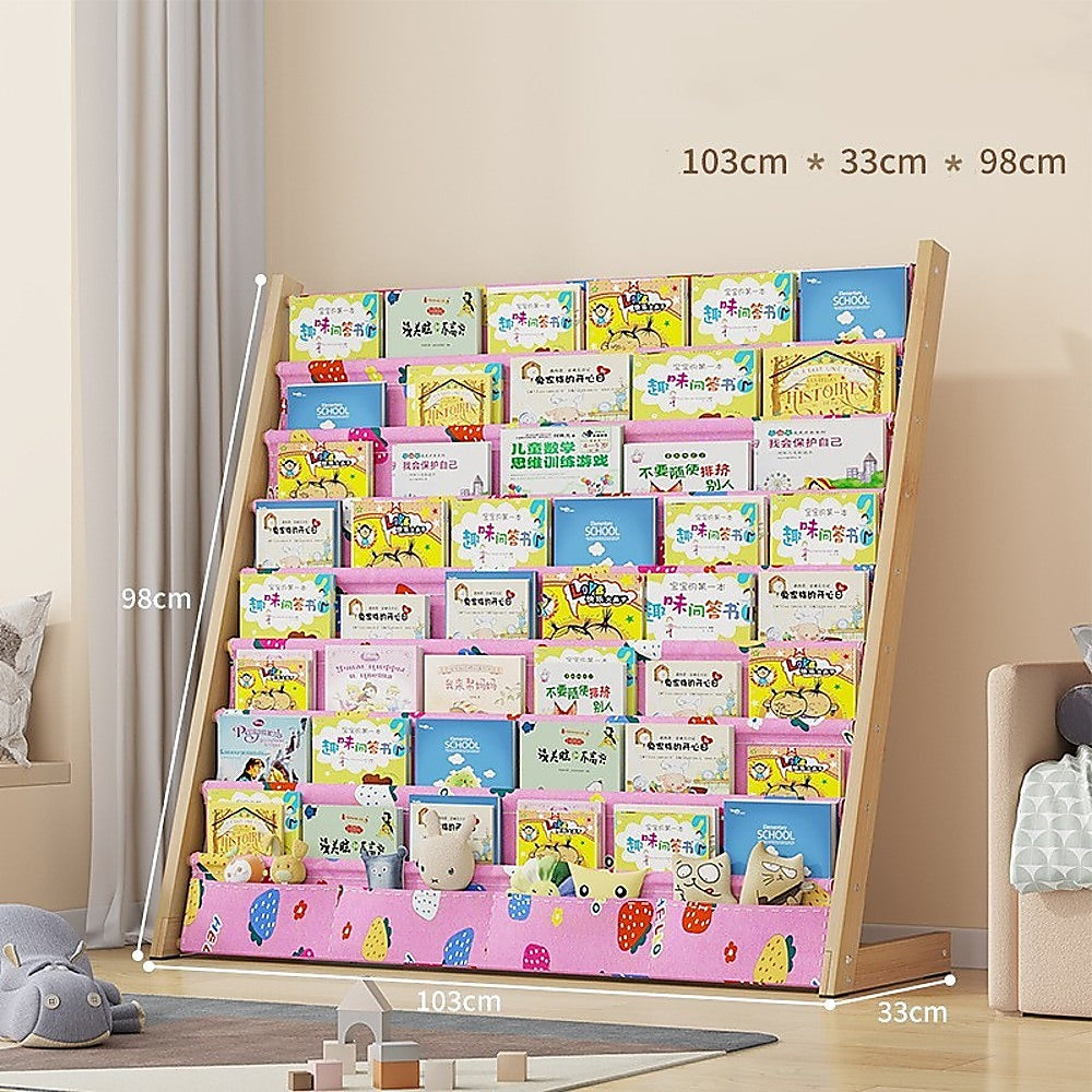 Kids pink fabric book display rack filled with children's books in playroom, dimensions: 103cm wide, 33cm deep, 98cm tall