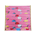 Close-up front view of pink strawberry-print fabric book display rack, empty pockets, bamboo uprights visible on sides