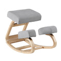 Grey fabric kneeling rocker chair with bentwood curved frame and padded seat and knee rest on white background