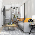 Full-motion TV wall bracket lifestyle in grey room with wall-mounted TV grey sofa orange cushions pendant lights