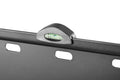 TV wall bracket spirit level close-up showing green bubble in dome housing on black bracket rail with oval slots