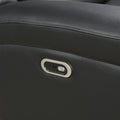 Close-up of black pebbled leather upholstery texture on power recliner sofa surface
