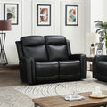 Black leather 2-seat power recliner loveseat in styled living room with framed artwork, plant and lamp