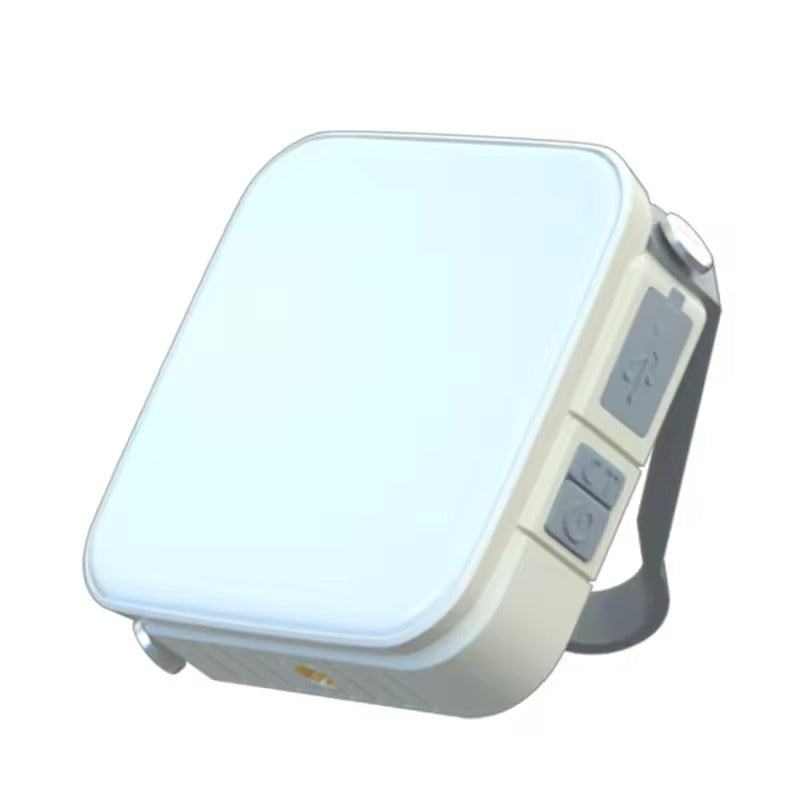 White square portable LED camping light with grey side buttons glowing bright, three-quarter view on white background