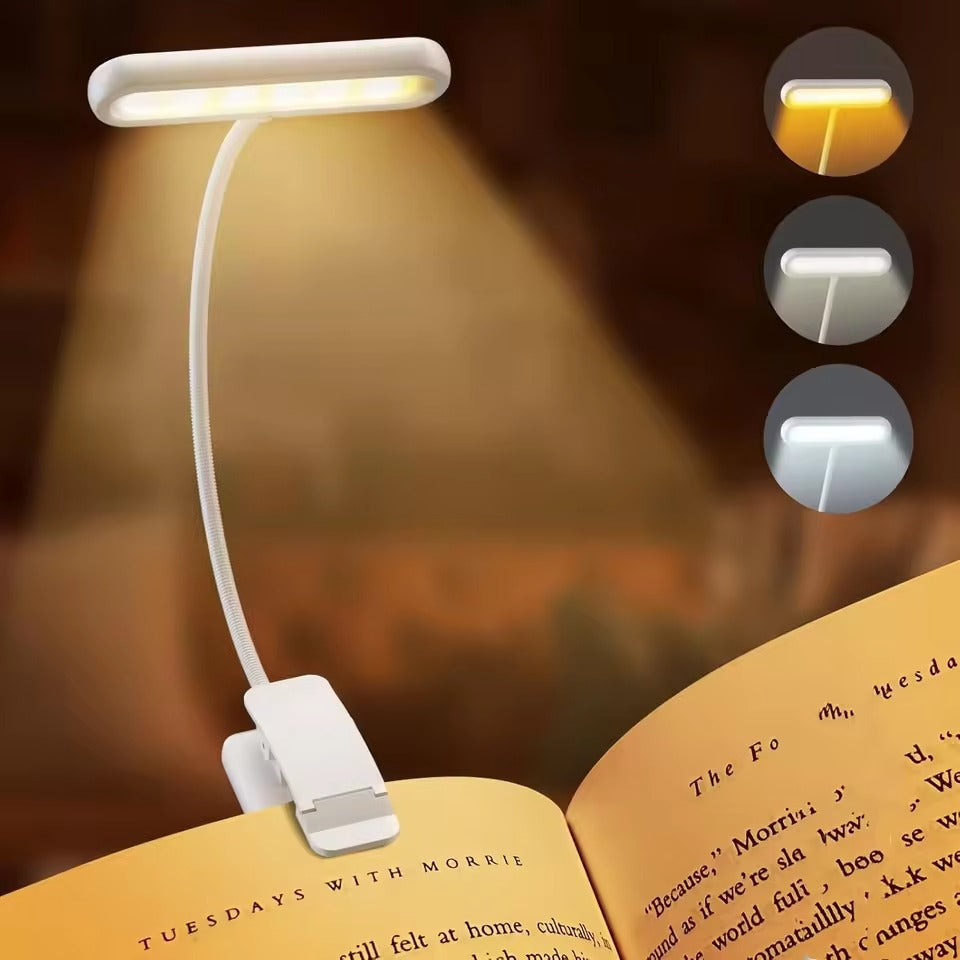 White LED clip-on reading light on flexible gooseneck arm clipped to open book, with three colour temperature mode insets