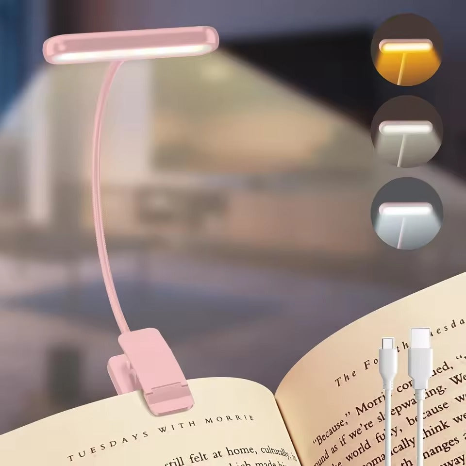 Pink LED clip-on reading light on flexible arm clipped to open book with USB-C cable and three colour temperature mode insets