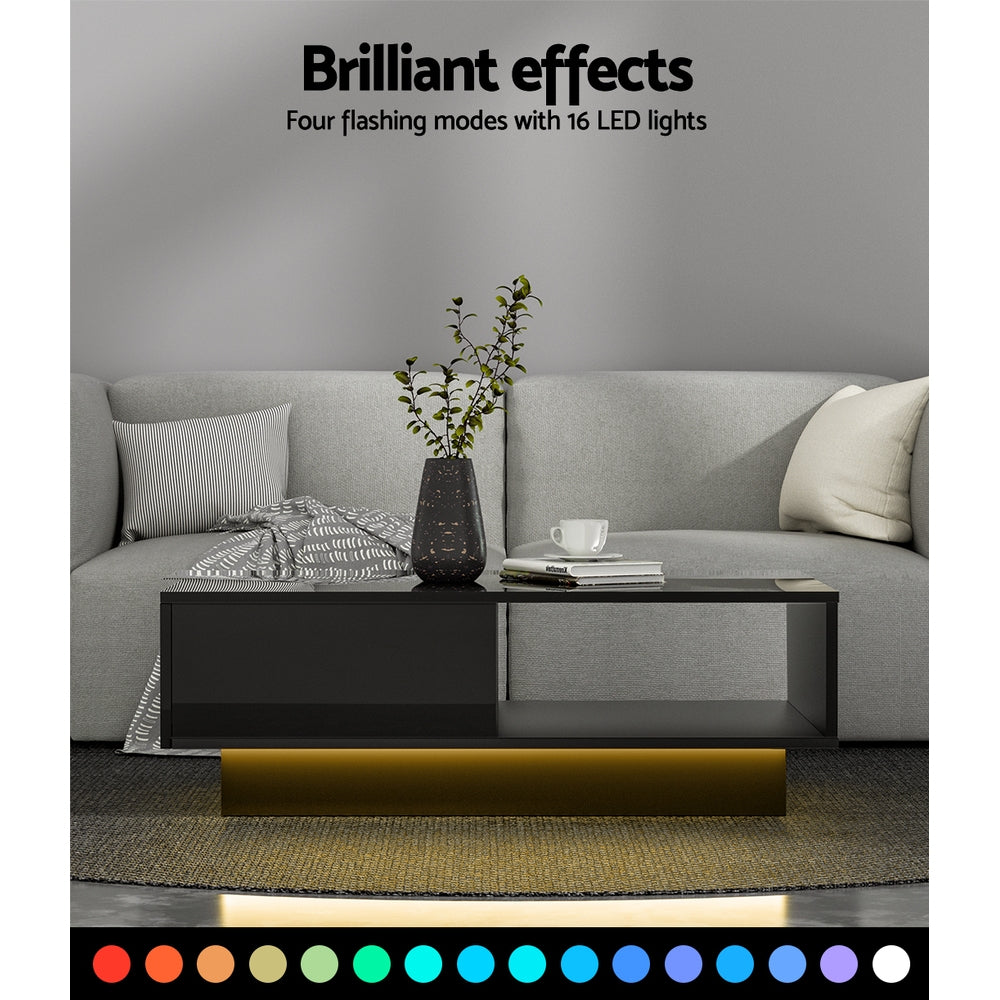 Black high-gloss coffee table with warm LED underglow light in a living room, with text reading Brilliant effects, four