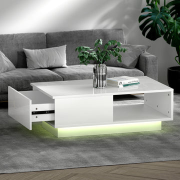 White high-gloss LED coffee table with a drawer pulled open on the left and open shelf on the right, glowing green LED base