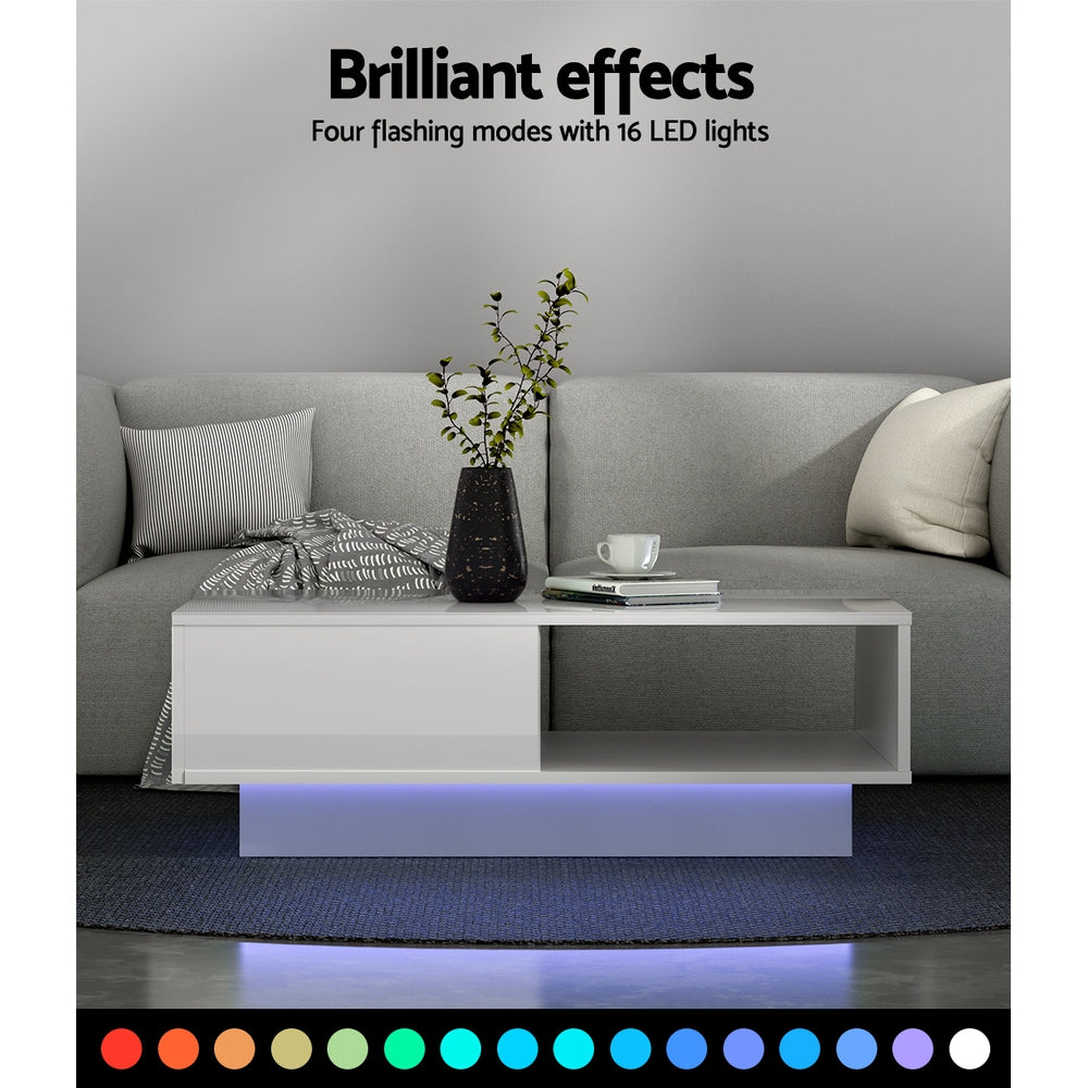 White high-gloss LED coffee table in a living room with blue LED underglow, text reading Brilliant effects, four flashing