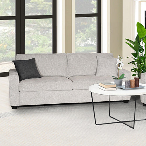 Light grey 3-seater sofa with one dark scatter cushion in living room with plant and coffee table