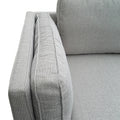 Light grey fabric 3-seater sofa close-up of armrest face showing woven fabric texture and piped seam